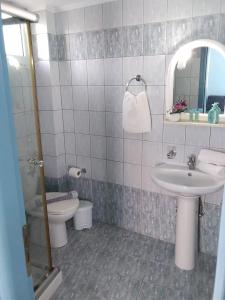 a bathroom with a sink and a toilet and a mirror at Mastorakis Village in Agia Marina Nea Kydonias +72 photos