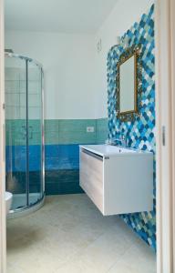 a bathroom with a sink and a glass shower at Maiori Dream House 1 in Maiori