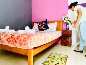 a woman is standing next to a bed in a room at Lisbon Prime Hostel & Rooms in Lisbon +42 photos