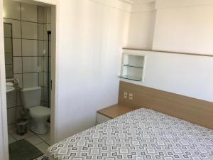 a small bathroom with a bed and a toilet at Apartamento Meireles in Fortaleza