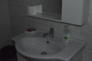 a bathroom sink with a bottle of soap on it at Christinas garden in Patra +20 photos