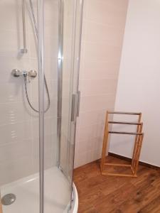 a shower in a bathroom with a glass shower stall at Apartman 11 MyMara in Bešeňová
