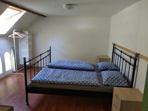 a bedroom with two beds with blue pillows on them at Chalupa Poustevník in Dolní Poustevna