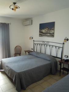 Postel nebo postele na pokoji v ubytování Hotel Punta Barone