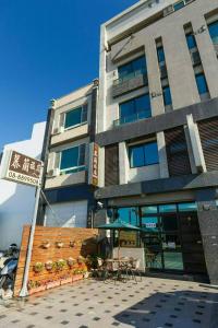 a building with tables and chairs in front of it at Kenting Mulan Homestay in Hengchun South Gate