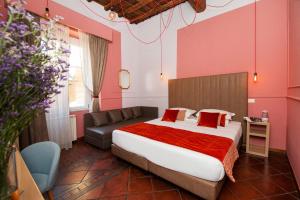 a bedroom with a large bed and a couch at Town House Campo De Fiori in Rome