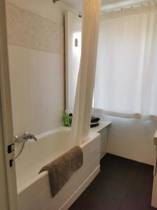 a bathroom with a bath tub and a sink at Au fil de l eau in Namur