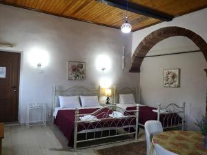 a bedroom with two beds and a table in a room at Clio apartments in Kambos