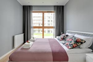 Ένα ή περισσότερα κρεβάτια σε δωμάτιο στο Maximus Apartment by TriApart