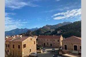 a view of a town with mountains in the background at FUNTANA NOVA in Piana
