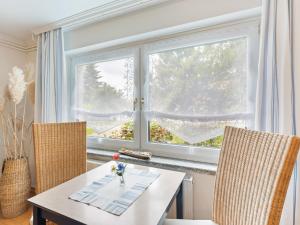 a dining room with a table and two chairs and a window at Einladende Ferienwohnung in Wismar in Wismar