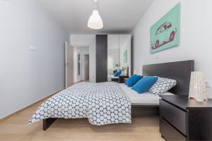 a bedroom with a large bed with blue pillows at FantaSEA apartment in Fažana