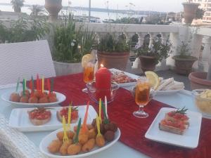 a table with plates of food and candles on it at Antico Palazzo Spinola in Gallipoli