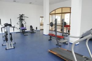 a gym with several tread machines and a mirror at Villa Romana in Topola