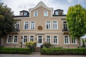 a large house with a fence in front of it at Loftapartment im historischen Fabrikambiente in Geisenheim +10 photos
