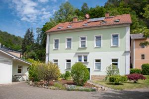 a large white house with a red roof at Haus Wettin in Bad Schandau