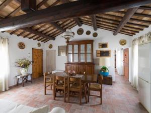una cucina e una sala da pranzo con tavolo e sedie di Casale Cenerelli a Castelfidardo