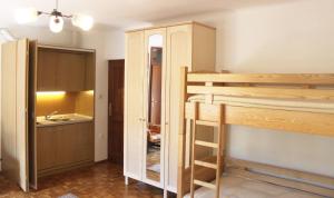 a room with a bunk bed and a kitchen at Homestead Zatrnik near Bled in Bled