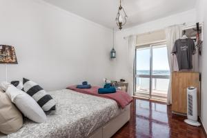 a bedroom with a bed with a view of the ocean at Sea View Fairy Tale in Faro