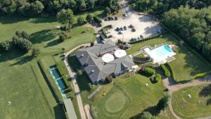 an aerial view of a house with a swimming pool at La Foresteria Canavese Golf & Country Club in Torre Canavese