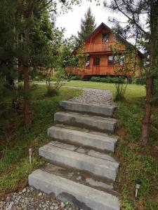 a set of concrete stairs leading to a house at Chrząszczewo Widokowe wzgórze 2 in Uherce Mineralne (7)