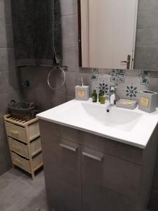 a bathroom with a white sink and a mirror at Melina's Studios in Argalasti