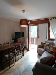 a living room with a table and a couch at Courma House in Courmayeur