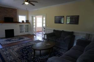 a living room with a couch and a table at Renovated 1928 bungalow on a former asylum campus in Milledgeville