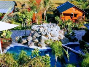 an aerial view of a garden with a rock waterfall at Cabañas la finca 2 in Atlixco