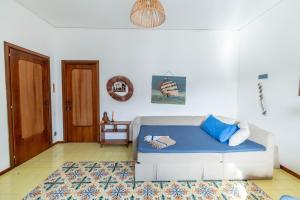 a living room with a white couch and blue pillows at Virginia's Guest House in Sorrento +36 photos