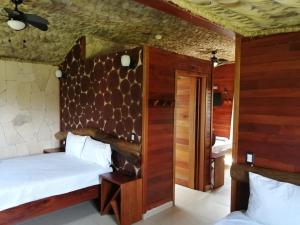 a bedroom with a bed and a wooden wall at Cabañas la finca 2 in Atlixco