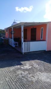 a red and white house with a porch at Studio with sea view terrace and wifi at Souillac 1 km away from the beach in Souillac