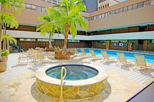 a large pool with chairs and a large swimming pool at Executive Hotel Suite Downtown Free Parking in Honolulu