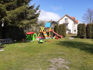 a playground in a yard with a house at Willa Feniks in Łeba