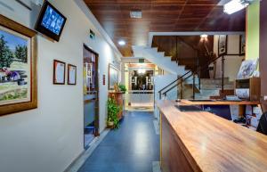 a hallway of a house with a counter and stairs at Hotel Ciudad de Martos in Martos