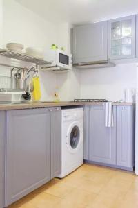 a kitchen with a washing machine and a sink at Flat near Lloret De Mar center and beach in Lloret de Mar