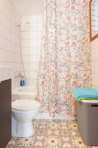 a bathroom with a toilet and a shower curtain at Flat near Lloret De Mar center and beach in Lloret de Mar