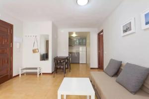 a living room with a couch and a table at Flat near Lloret De Mar center and beach in Lloret de Mar