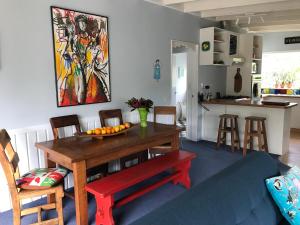 a dining room table with a bowl of fruit on it at Blue in Pohara