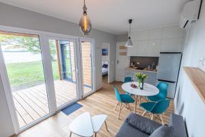 a kitchen and living room with a table and chairs at Mazurski Widok in Wydminy