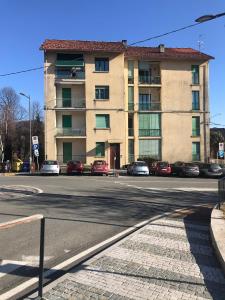 a building with cars parked on the side of a street at Da Lumi Relax in Lanzo Torinese