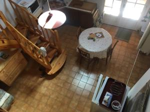an overhead view of a dining room with a table and chairs at Jolie petite maison dans hameau en pleine nature in Taussac-la-Billière +9 photos