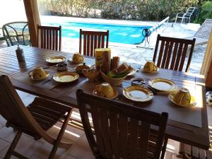 a wooden table with food on top of it at les chambres de Rocbaron in Rocbaron