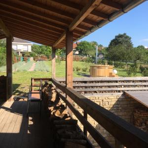 un patio con techo de madera y pared de piedra en "Domaine de la Mance" - Gite-Maison de vacances, en Vitrey