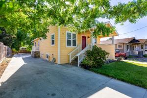 a yellow house with a driveway at @ Marbella Lane Mini Guest House in Downtown San Jose in San Jose