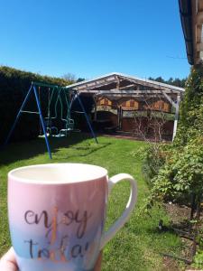 a coffee cup with the words happy holidays written on it at Morski Bobolin in Bobolin