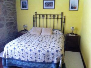 a bedroom with a bed and two night stands with two lamps at Casa das Augas Santas in Aguas Santas