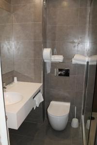 a bathroom with a toilet and a sink at Hôtel La Peupleraie in Nampont-Saint-Martin