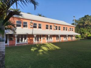 a large building with a palm tree in front of it at Sica's Guest House in Durban