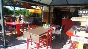 a restaurant with tables and chairs under an umbrella at Casa Bihan Ty Coat in Lannion +5 photos